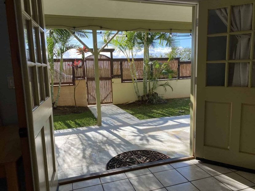 The Sunset door standing open onto the lawn and the lanai.