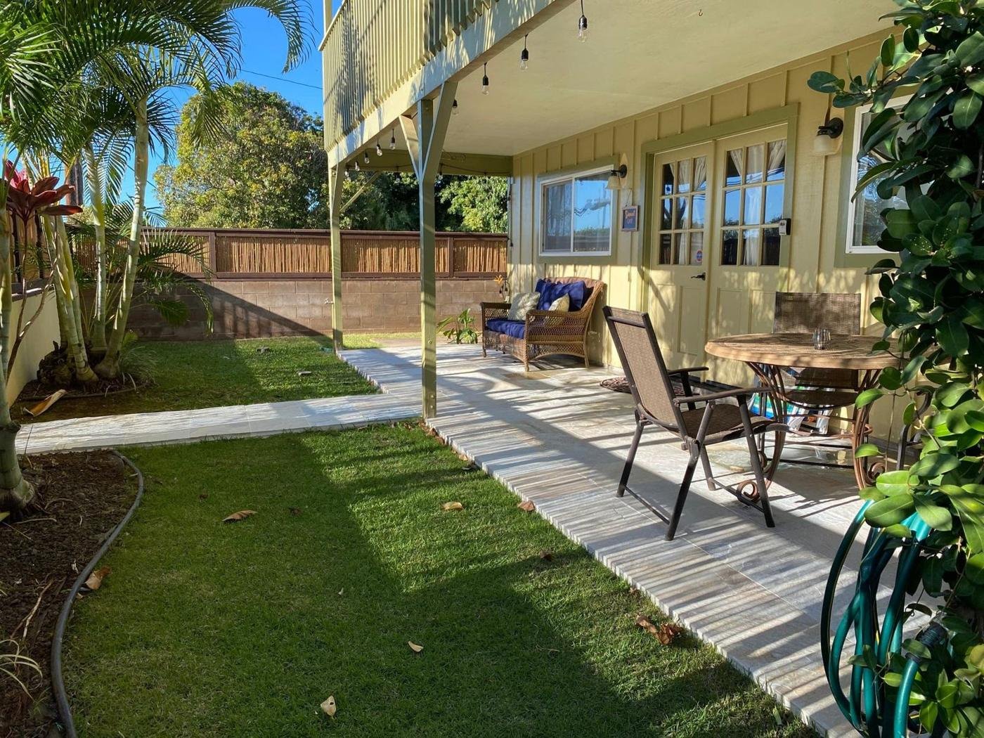 The garden walkway alongside the house leading past the lawn to the covered lanai.